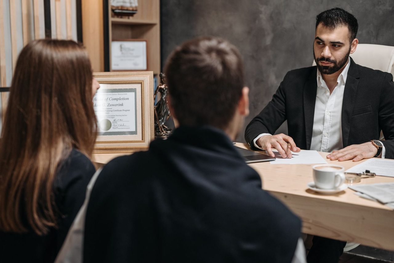 Attorney reviewing documents with clients at a conference table